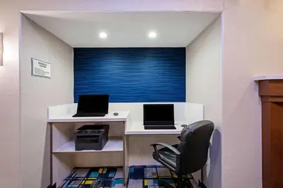 a office with two computers on a desk with a chair at La Quinta by Wyndham Manteca - Ripon in Ripon