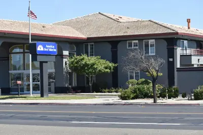 a blue building with a sign in front of it at Baymont by Wyndham Manteca in Manteca