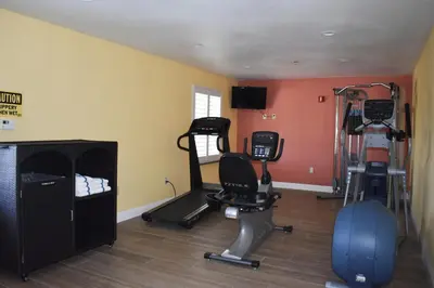 a gym with several tread machines in a room at Baymont by Wyndham Manteca in Manteca