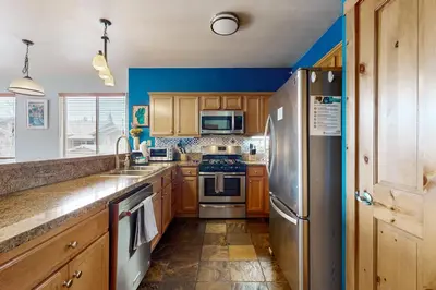 a kitchen with wooden cabinets and a stainless steel refrigerator at Truckee Living in Truckee