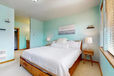 a bedroom with a bed and a blue wall at Truckee Living in Truckee