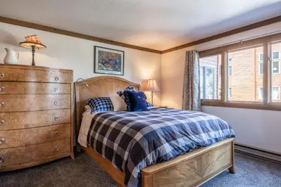 a bedroom with a bed and a dresser and a window at Brand New Listing! 5 minute walk to Canyon Lodge! Newly Updated Two-Bed, Two-Bath, Mountainback #14 in Mammoth Lakes