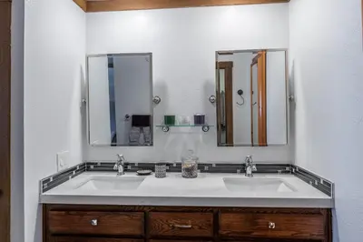 a bathroom with two sinks and two mirrors at Brand New Listing! 5 minute walk to Canyon Lodge! Newly Updated Two-Bed, Two-Bath, Mountainback #14 in Mammoth Lakes