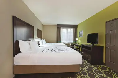 a hotel room with a large bed and a television at La Quinta by Wyndham Los Banos in Los Banos
