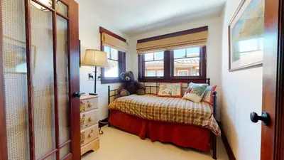 a small bedroom with a bed and a window at Juniper Crest #24 townhouse in Mammoth Lakes