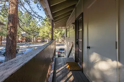a porch of a house with a door and a tree at New Listing Updated 1 Bed and Loft 2 Full Bath La Residence IV N7 Sleeps 4 and Steps to Free Shuttle in Mammoth Lakes