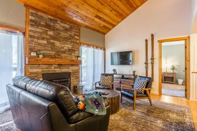 a living room with a leather couch and a fireplace at New Listing Updated 1 Bed and Loft 2 Full Bath La Residence IV N7 Sleeps 4 and Steps to Free Shuttle in Mammoth Lakes