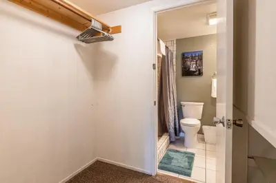 a bathroom with a white toilet and a door at New Listing Updated 1 Bed and Loft 2 Full Bath La Residence IV N7 Sleeps 4 and Steps to Free Shuttle in Mammoth Lakes