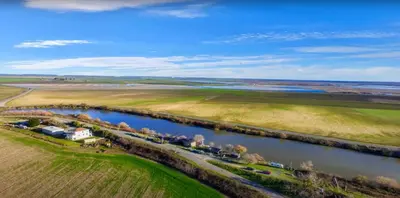 an aerial view of a river and a farm at Year-round fishing, boating, birding, 1 hr from SF in Walnut Grove