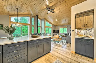 a kitchen with gray cabinets and a ceiling fan at Bikes, Grill and Views Luxe Truckee Cabin! in Truckee