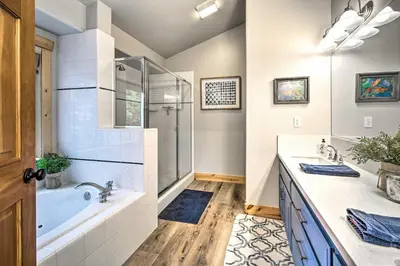 a bathroom with a tub and two sinks and a shower at Bikes, Grill and Views Luxe Truckee Cabin! in Truckee