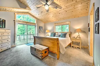 a bedroom with a bed and a wooden ceiling at Bikes, Grill and Views Luxe Truckee Cabin! in Truckee