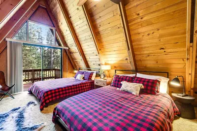 a bedroom with two beds in a log cabin at Heavenly Daze in Arnold