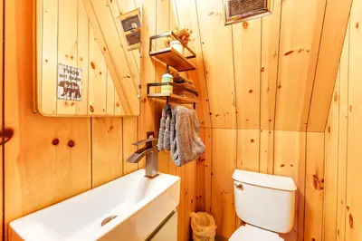 a bathroom with a white toilet and a sink at Heavenly Daze in Arnold