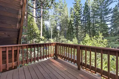 a wooden deck with a view of the woods at Heavenly Daze in Arnold
