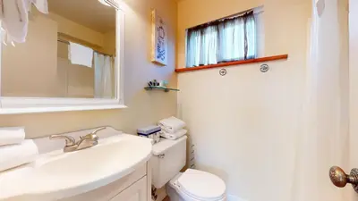 a bathroom with a sink and a toilet and a mirror at Mammoth View Villas #3 condo in Mammoth Lakes
