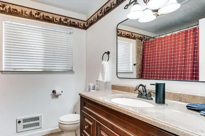 a bathroom with a sink and a mirror at Arnold Family Cabin with Hot Tub, Arcade and Deck in Arnold