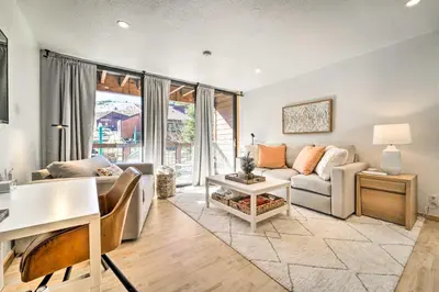 a living room with a couch and a table at Walk to Ski Resort Tahoe Donner Studio with Balcony in Truckee