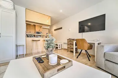 a living room with a couch and a table at Walk to Ski Resort Tahoe Donner Studio with Balcony in Truckee