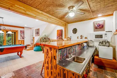 a kitchen with a sink and a pool table at Worth The Waite in Arnold