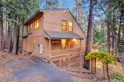 a tiny house in the woods with a driveway at Worth The Waite in Arnold