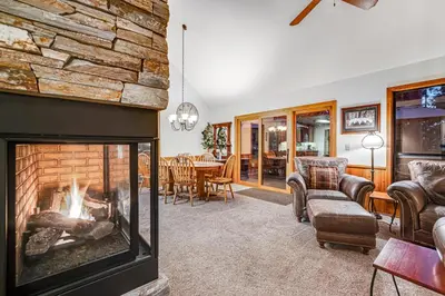 a living room with a fireplace and a table at Worth The Waite in Arnold