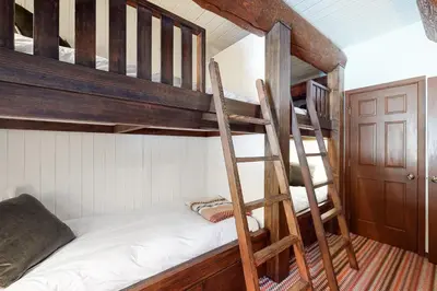 a bedroom with two bunk beds with a ladder at Kia Ora Northwoods in Truckee