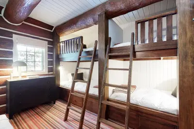 a room with two bunk beds and a desk at Kia Ora Northwoods in Truckee