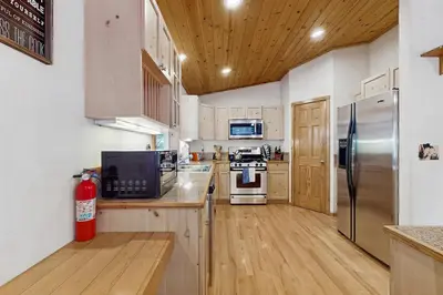 a kitchen with stainless steel appliances and wooden cabinets at Laurelwood Manor in Truckee