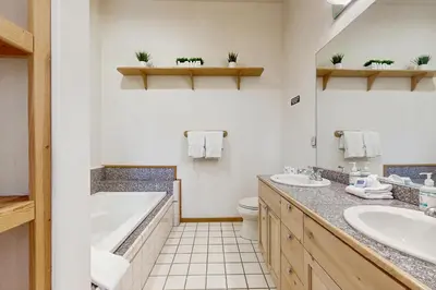 a bathroom with two sinks and a tub and a toilet at Laurelwood Manor in Truckee