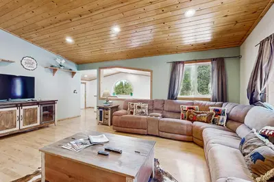 a living room with a couch and a tv at Laurelwood Manor in Truckee