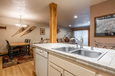 a kitchen with a sink and a living room at New Listing Updated 1 bedrm 1 bath Summit H Building #95 condo Just steps to Eagle Lodge sleeps 4 in Mammoth Lakes