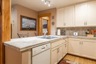 a kitchen with white cabinets and a sink at New Listing Updated 1 bedrm 1 bath Summit H Building #95 condo Just steps to Eagle Lodge sleeps 4 in Mammoth Lakes