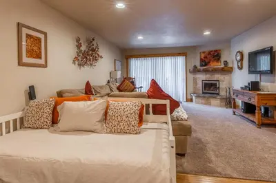 a living room with a bed and a couch at New Listing Updated 1 bedrm 1 bath Summit H Building #95 condo Just steps to Eagle Lodge sleeps 4 in Mammoth Lakes