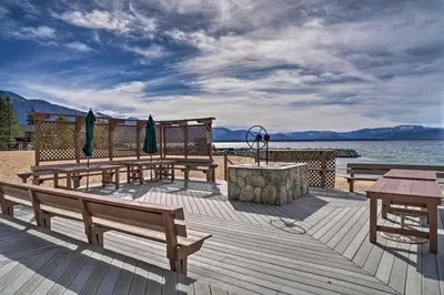 a group of benches sitting on a deck near the water at Deck and Beach Access Lake Tahoe Shoreside Retreat! in Elk Point