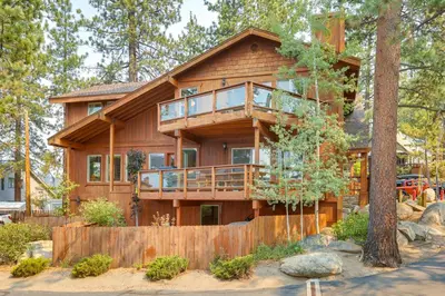a large wooden house with a wrap around deck at Deck and Beach Access Lake Tahoe Shoreside Retreat! in Elk Point