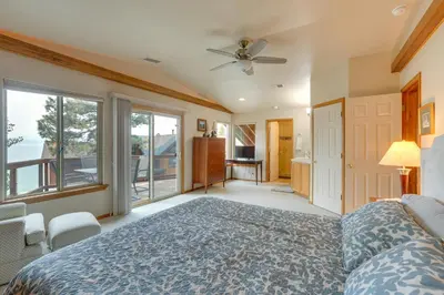 a bedroom with a bed and a large window at Deck and Beach Access Lake Tahoe Shoreside Retreat! in Elk Point