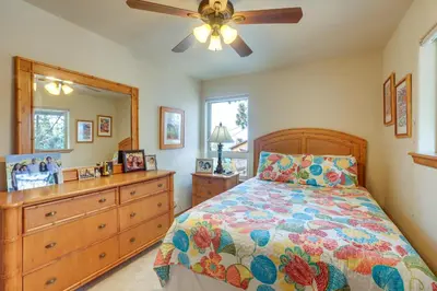 a bedroom with a bed and a dresser and a ceiling fan at Deck and Beach Access Lake Tahoe Shoreside Retreat! in Elk Point