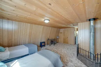 a bedroom with two beds and a wooden ceiling at Quiet Sequoia National Forest Cabin with Fireplace in Posey