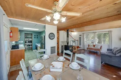 a dining room and living room with a table at Quiet Sequoia National Forest Cabin with Fireplace in Posey