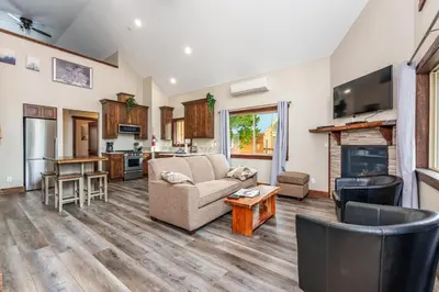 a living room with a couch and a table at Devonshire - Aragon in Yosemite West