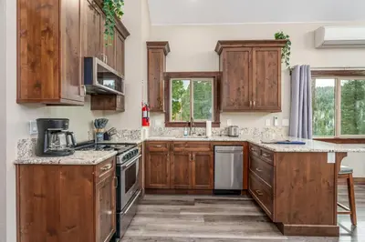 a kitchen with wooden cabinets and a counter top at Devonshire - Aragon in Yosemite West