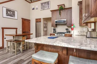a kitchen with wooden cabinets and a counter top at Devonshire - Aragon in Yosemite West