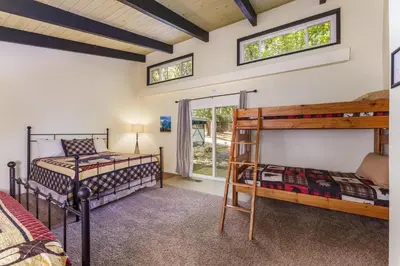 a bedroom with two bunk beds and a window at Cedar Nest in Wawona