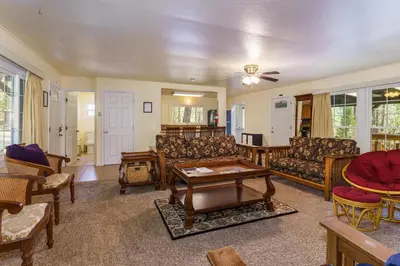 a living room with couches and a table at Cedar Nest in Wawona