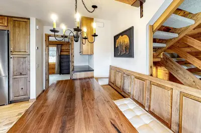a dining room with a wooden table and wooden ceilings at Ski Run Villas 8 in Mammoth Lakes