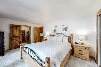 a bedroom with a large bed and a wooden dresser at Ski Run Villas 8 in Mammoth Lakes
