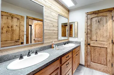 a bathroom with two sinks and two mirrors at Ski Run Villas 8 in Mammoth Lakes