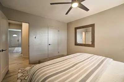 a bedroom with a bed and a ceiling fan at Game Room and Putting Green Reno Home! in Reno