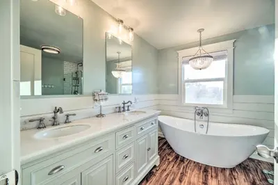 a bathroom with two sinks and a large mirror at Bethel Island Sanctuary with Dock and Boathouse in Oakley